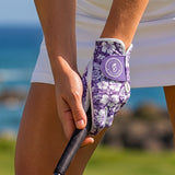 Woman wearing a Bright Golf Purple Hawaiian golf glove on the course