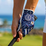 Woman wearing a Patriotic Stars women’s golf glove while holding a golf club